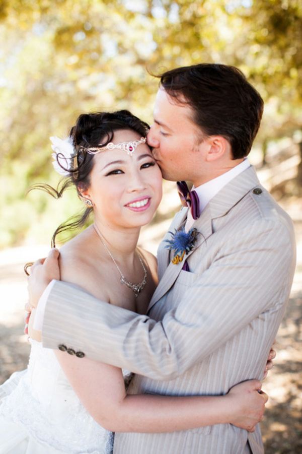 bride groom smiling - A costume wedding with winged shoes, fist bumps, and an Indiana Jones groom bride groom smiling