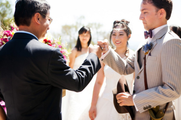 officiant fist bump - A costume wedding with winged shoes, fist bumps, and an Indiana Jones groom officiant fist bump