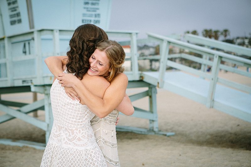 An aerial silk chuppah and two stunning gowns at this sweet beach wedding