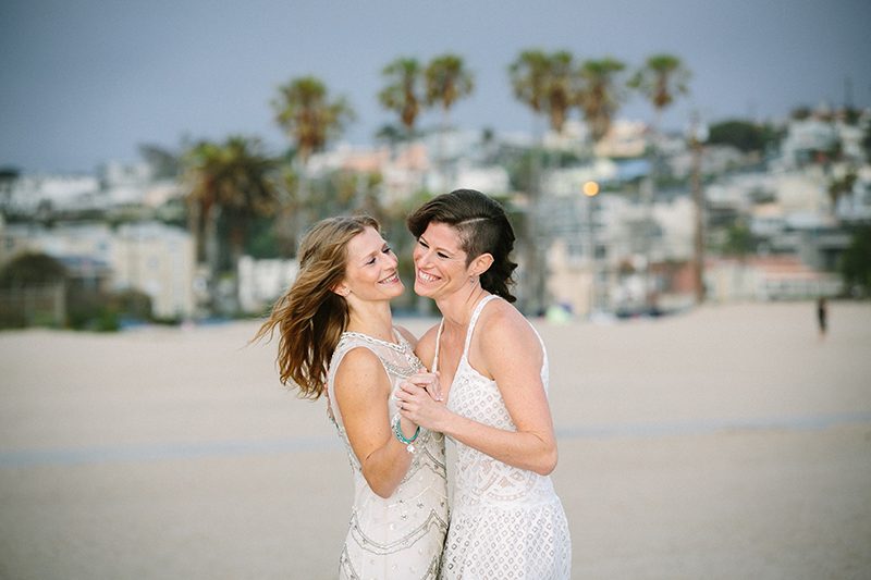 An aerial silk chuppah and two stunning gowns at this sweet beach wedding