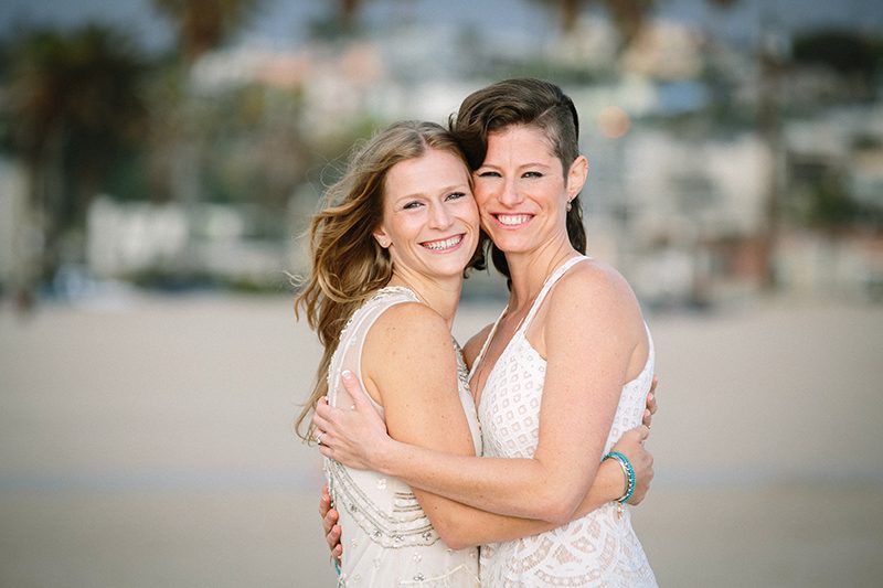 An aerial silk chuppah and two stunning gowns at this sweet beach wedding