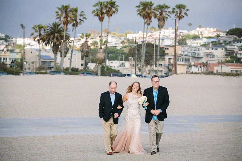 An aerial silk chuppah and two stunning gowns at this sweet beach wedding
