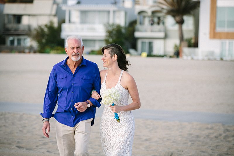 An aerial silk chuppah and two stunning gowns at this sweet beach wedding
