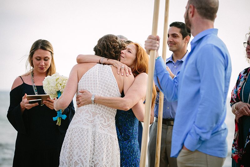 An aerial silk chuppah and two stunning gowns at this sweet beach wedding