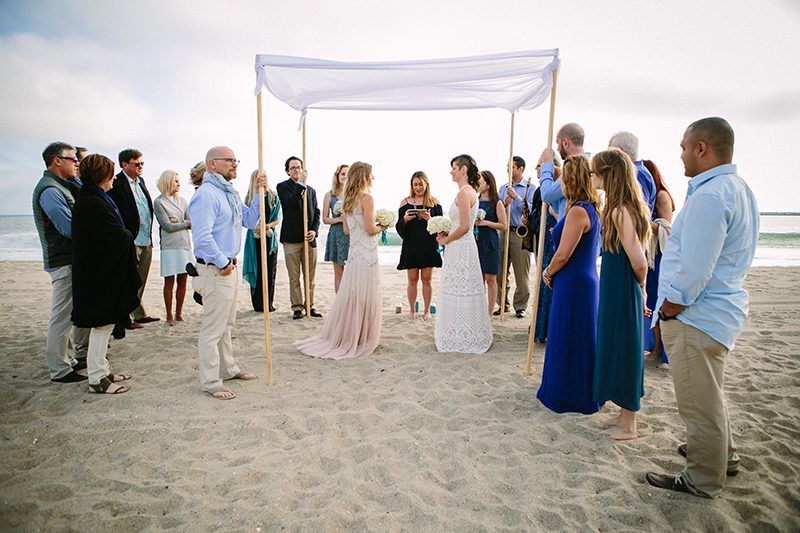 An aerial silk chuppah and two stunning gowns at this sweet beach wedding