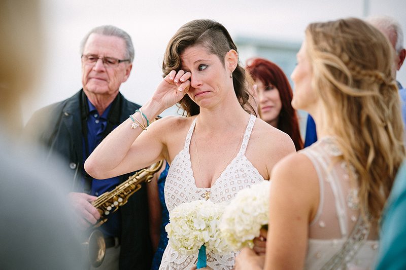 An aerial silk chuppah and two stunning gowns at this sweet beach wedding