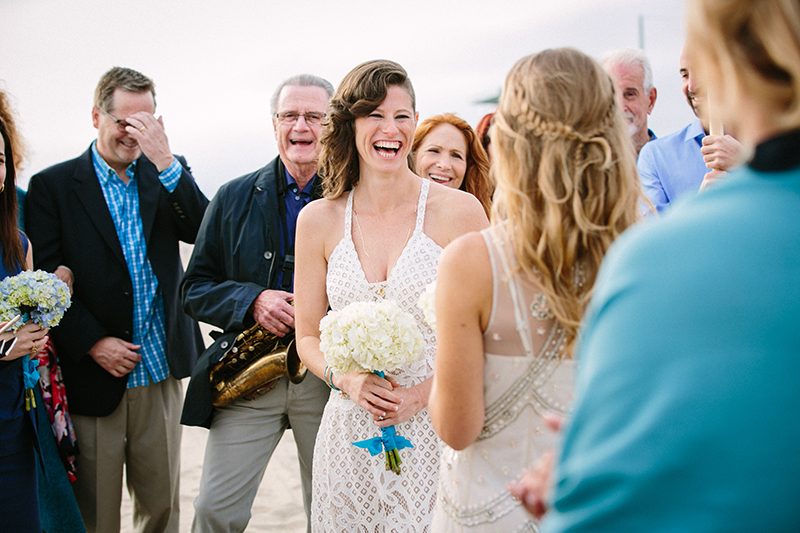 An aerial silk chuppah and two stunning gowns at this sweet beach wedding