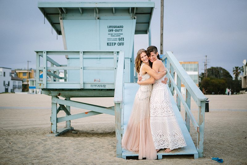 An aerial silk chuppah and two stunning gowns at this beach wedding