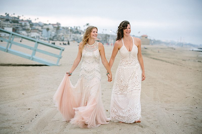 An aerial silk chuppah and two stunning gowns at this beach wedding