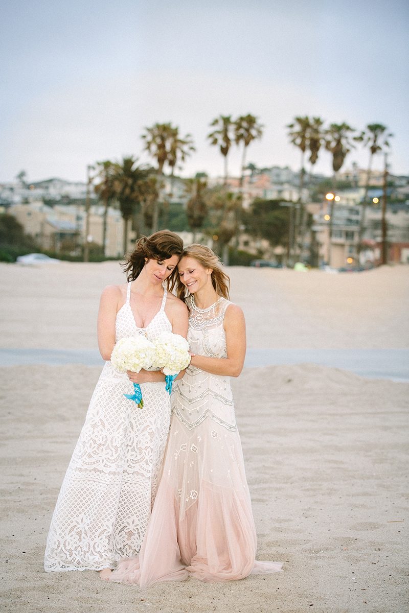 An aerial silk chuppah and two stunning gowns at this beach wedding