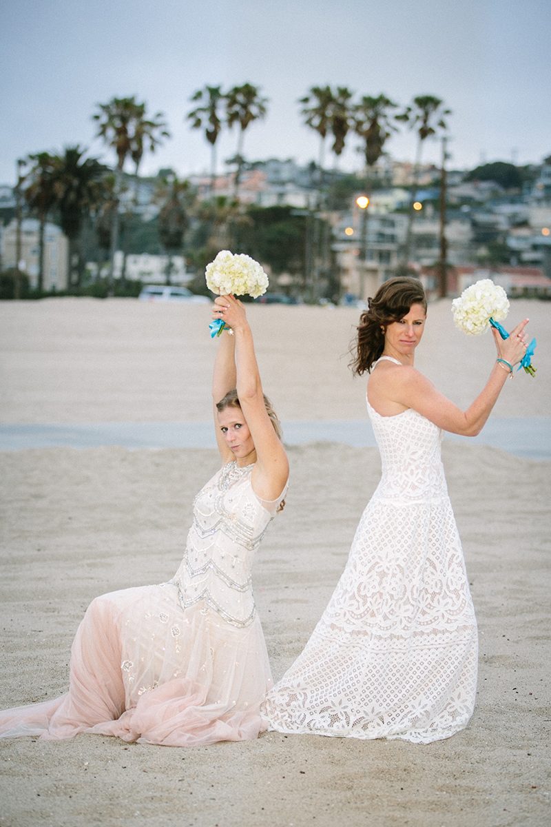 An aerial silk chuppah and two stunning gowns at this beach wedding