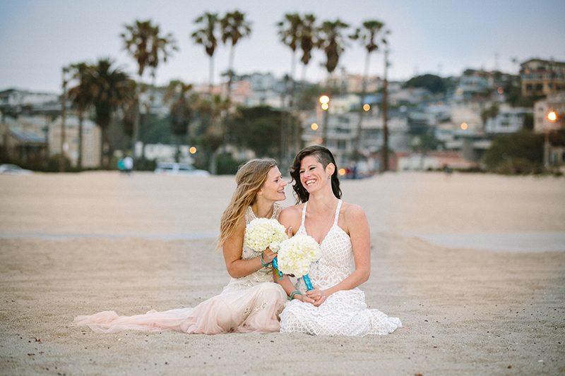 An aerial silk chuppah and two stunning gowns at this beach wedding