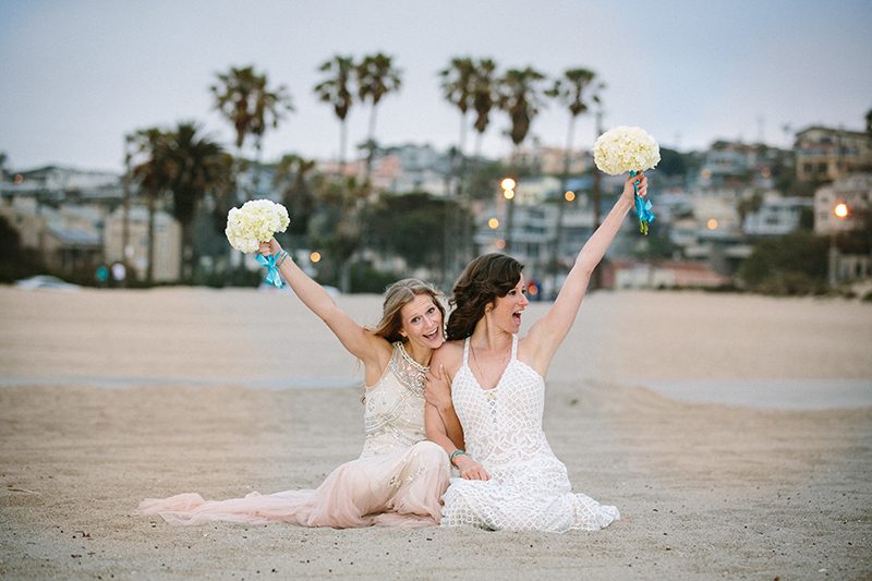 An aerial silk chuppah and two stunning gowns at this beach wedding