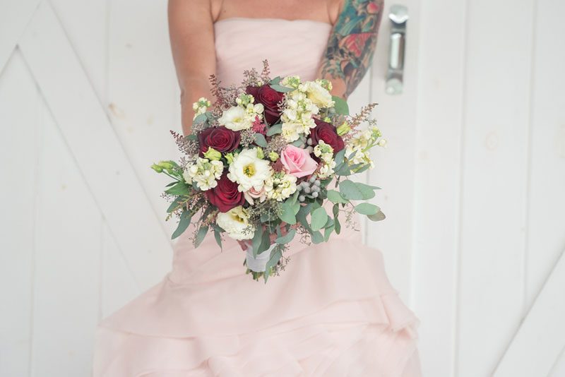 We heart the pink dress and hanky bags at this barn wedding