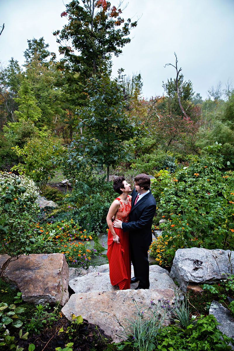 Intimate, rustic DIY fall-themed wedding celebration with red-dressed bride