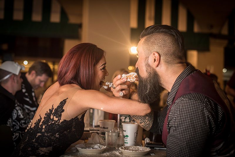 A glam Halloween wedding with a black dress and beignets