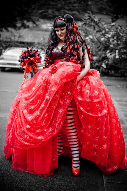 A bride in a red wedding dress & striped tights