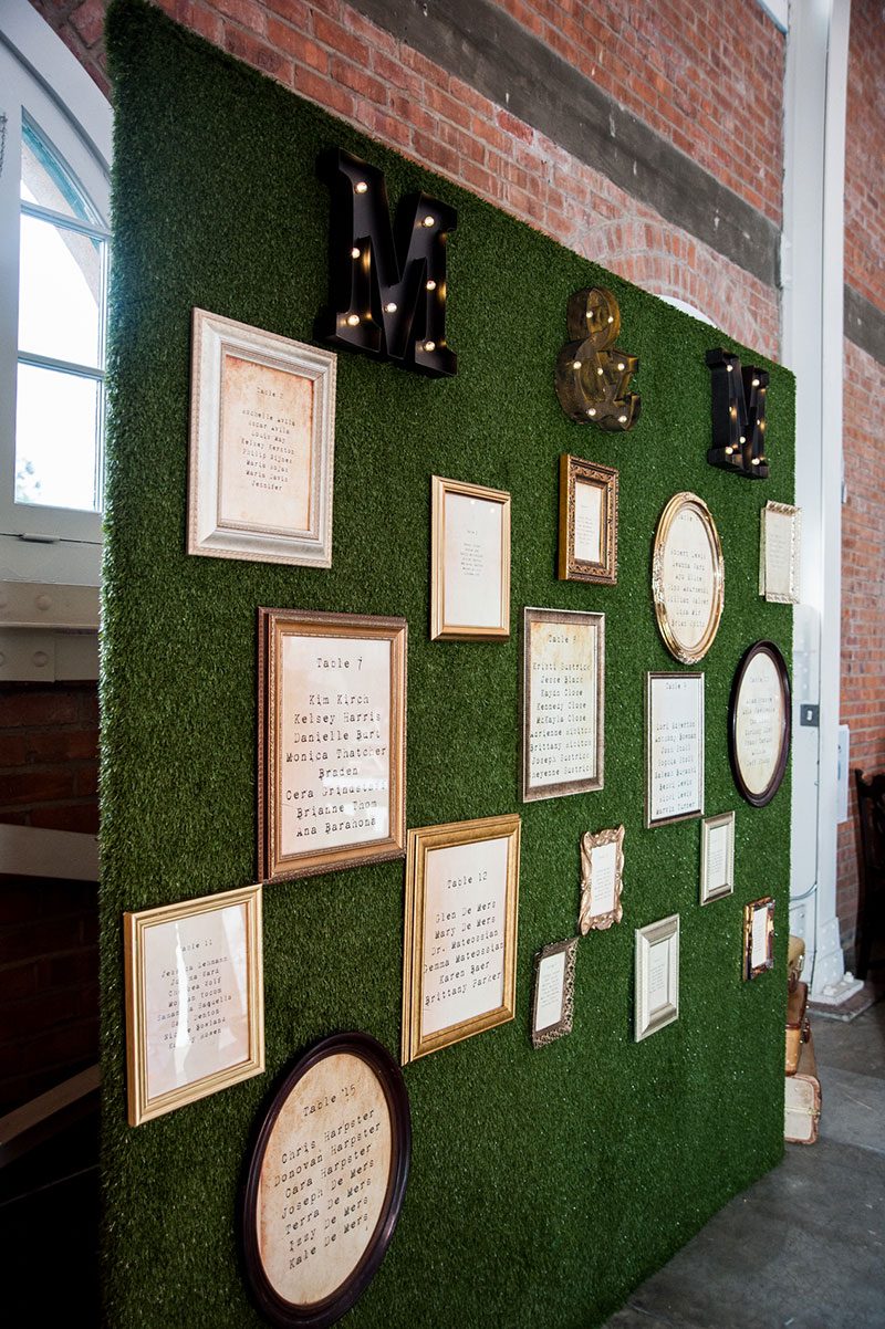How fake grass + picture frames = the most kick-ass seating chart display