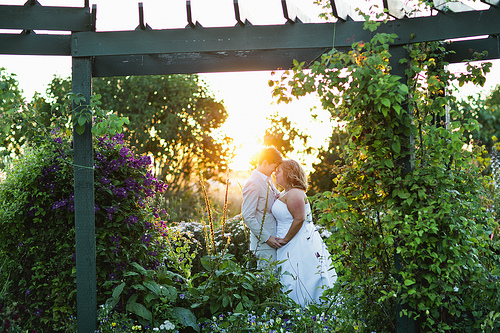 Two brides, two officiants, and a flower girl in a suit at this Sequim wedding