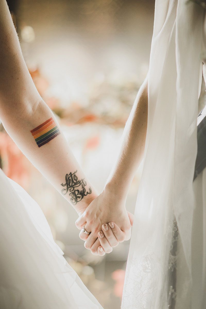An Autumn witch lesbian wedding with tarot, tattoos, and beer