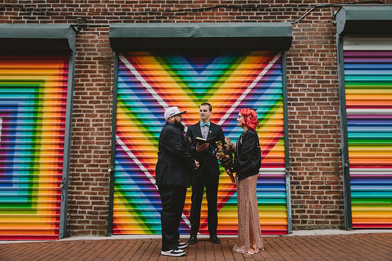 This rad pop-up wedding had glitter, sequins, and huge rainbow mural LOVE