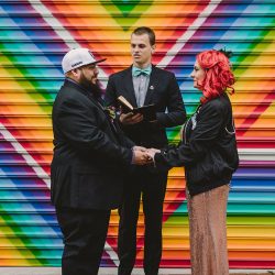 This rad pop-up wedding had glitter, sequins, and huge rainbow mural LOVE
