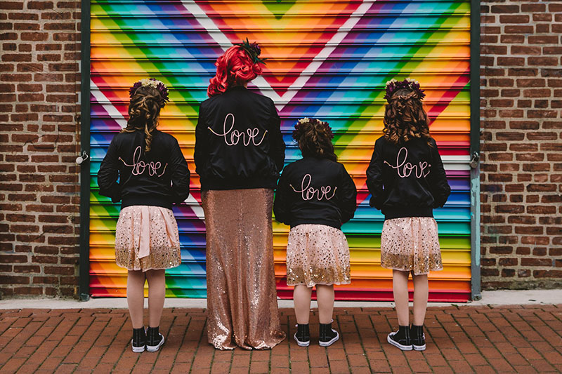 This rad pop-up wedding had glitter, sequins, and huge rainbow mural LOVE