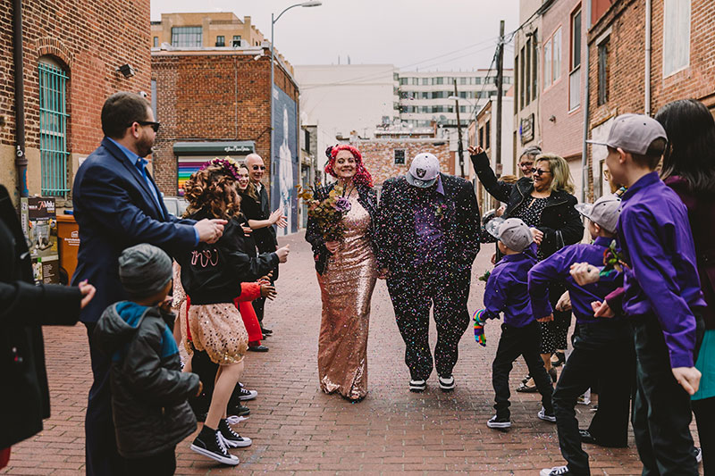 This rad pop-up wedding had glitter, sequins, and huge rainbow mural LOVE