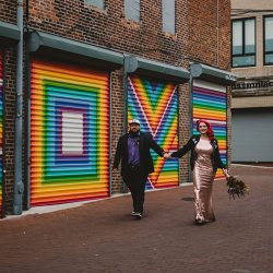 This rad pop-up wedding had glitter, sequins, and huge rainbow mural LOVE