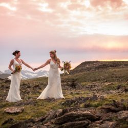 Two brides, a mountainside wedding, and cotton candy skies