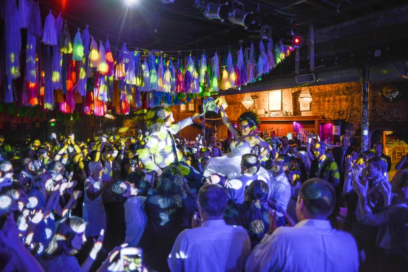 Don't miss the floral dresses, colorful art, and live band at this adorable Colorado wedding