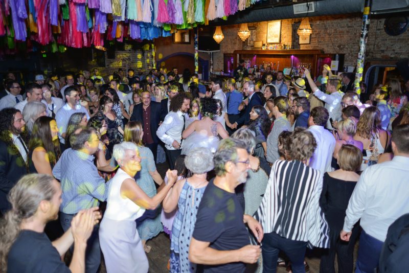 Don't miss the floral dresses, colorful art, and live band at this adorable Colorado wedding