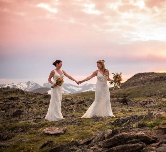 Two brides, a mountain view wedding, and cotton candy skies