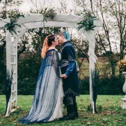 Spot the pups, swords, & EPIC cape at this fantasy themed wedding