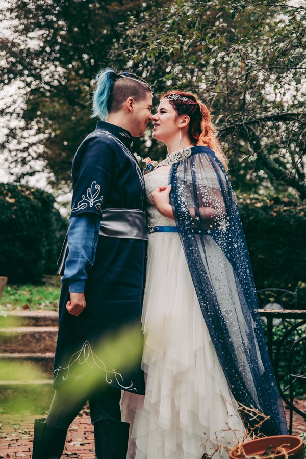 Spot the pups, swords, & EPIC cape at this fantasy themed wedding