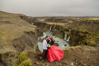 Hidden waterfalls & mountain views at this Iceland elopement with a fab red dress