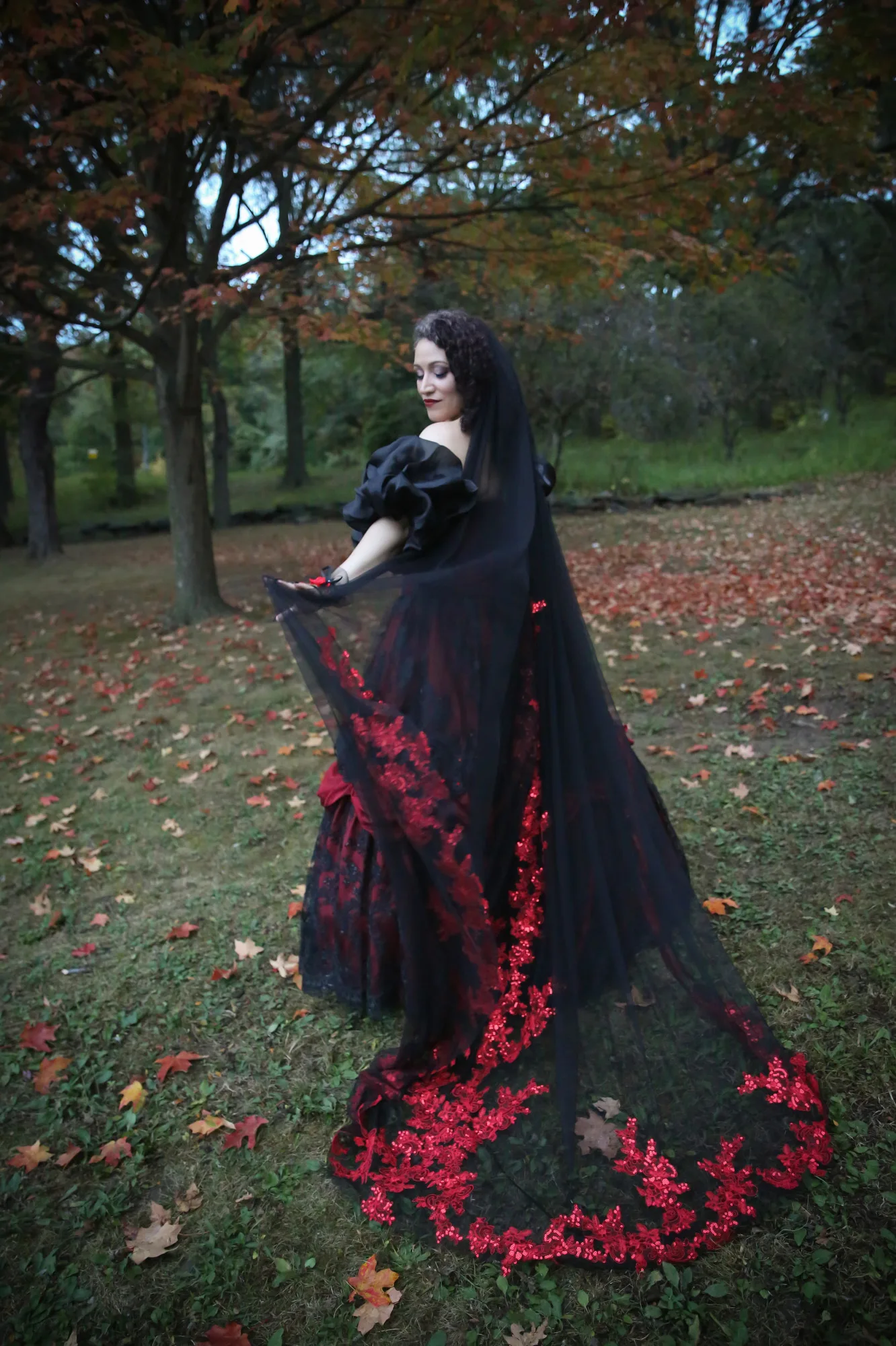 A Goth bride wears a red and black dress at her New York wedding.