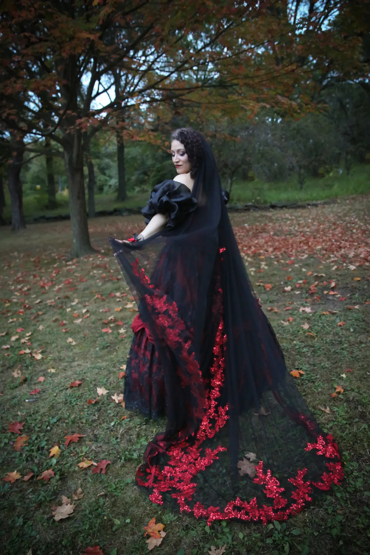 A Goth bride wears a red and black dress at her New York wedding.