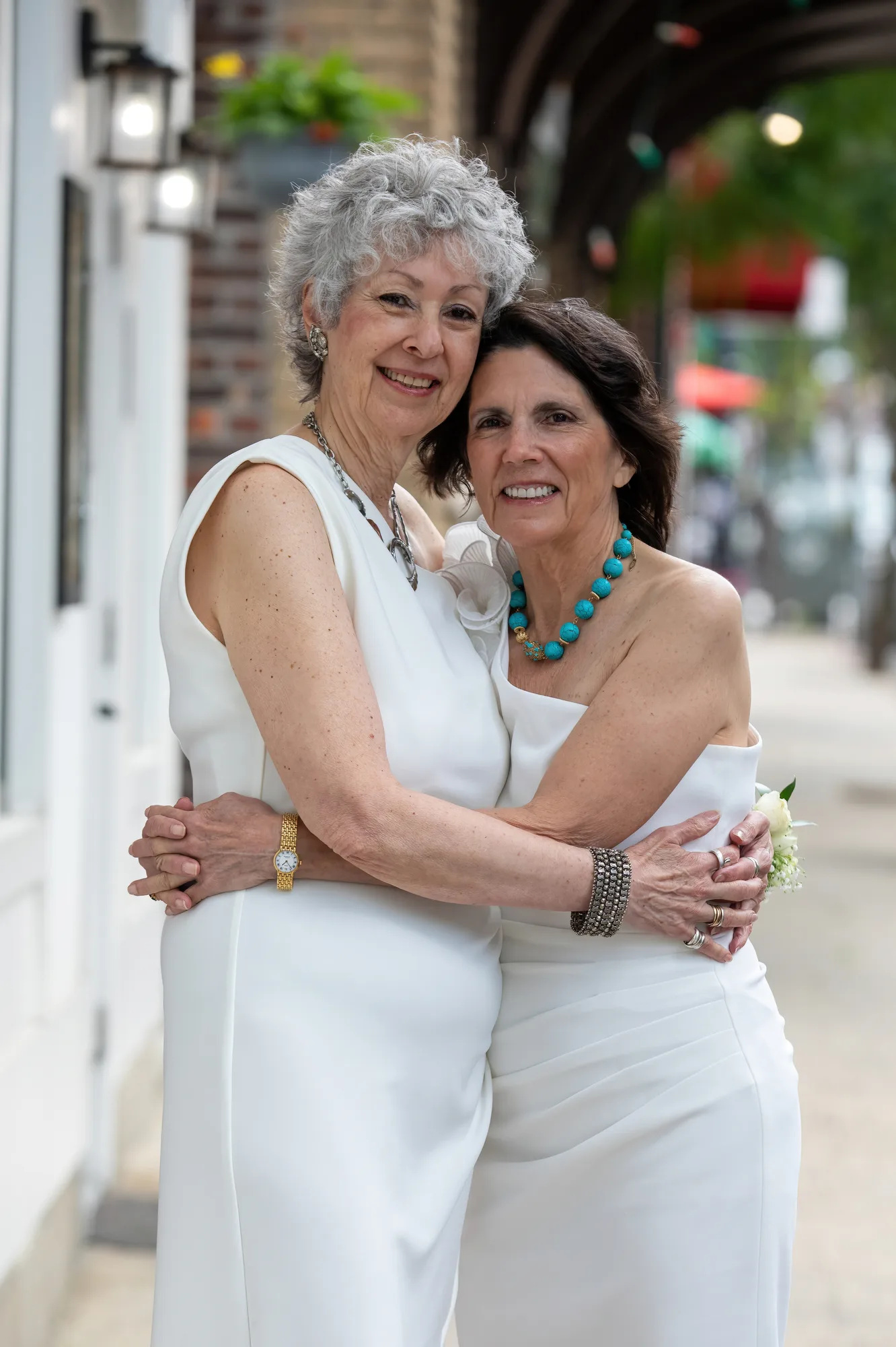 Two older brides embrace at their New York lesbian wedding.