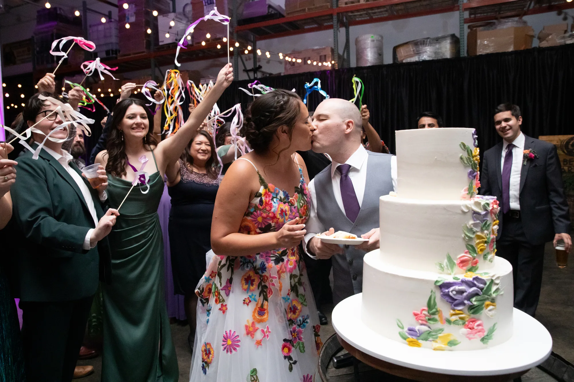Guests wave colorful ribbon wands during a wedding reception at Captain Lawrence Brewery in the Hudson Valley.