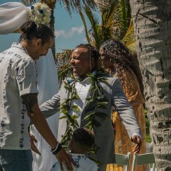 A romantic O'ahu wedding with two grooms, a beachside ceremony, & jumping the "groomstick"