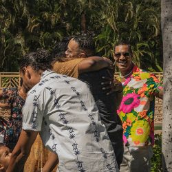A romantic O'ahu wedding with two grooms, a beachside ceremony, & jumping the "groomstick"