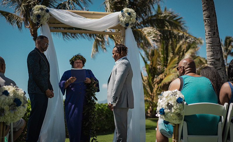 A romantic O'ahu wedding with two grooms, a beachside ceremony, & jumping the "groomstick"