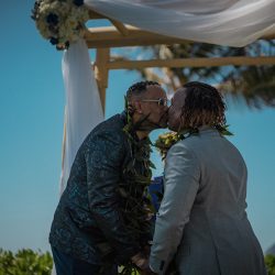 A romantic O'ahu wedding with two grooms, a beachside ceremony, & jumping the "groomstick"