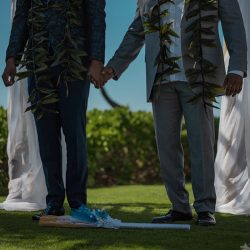 A romantic O'ahu wedding with two grooms, a beachside ceremony, & jumping the "groomstick"