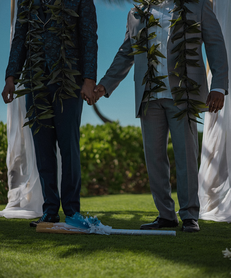A romantic O'ahu wedding with two grooms, a beachside ceremony, & jumping the "groomstick"