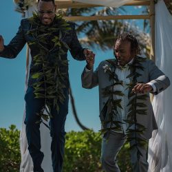 A romantic O'ahu wedding with two grooms, a beachside ceremony, & jumping the "groomstick"