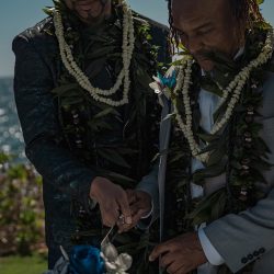 A romantic O'ahu wedding with two grooms, a beachside ceremony, & jumping the "groomstick"