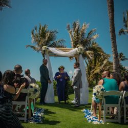 A romantic O'ahu wedding with two grooms, a beachside ceremony, & jumping the "groomstick"