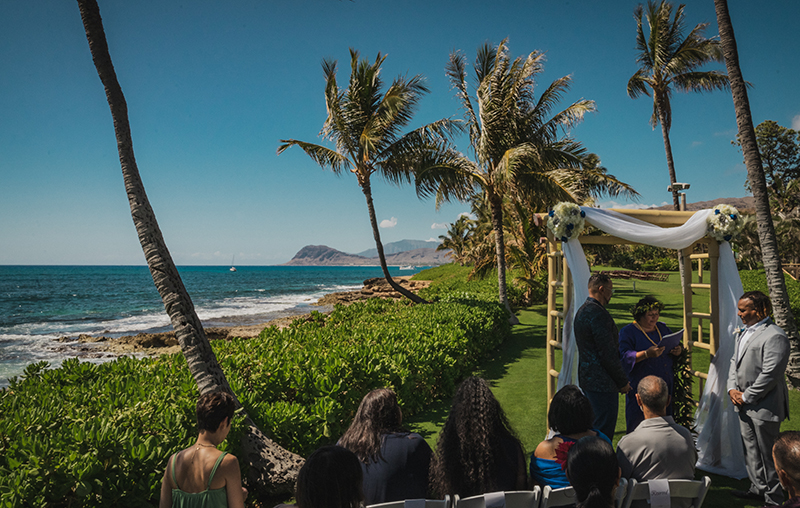 A romantic O'ahu wedding with two grooms, a beachside ceremony, & jumping the "groomstick"